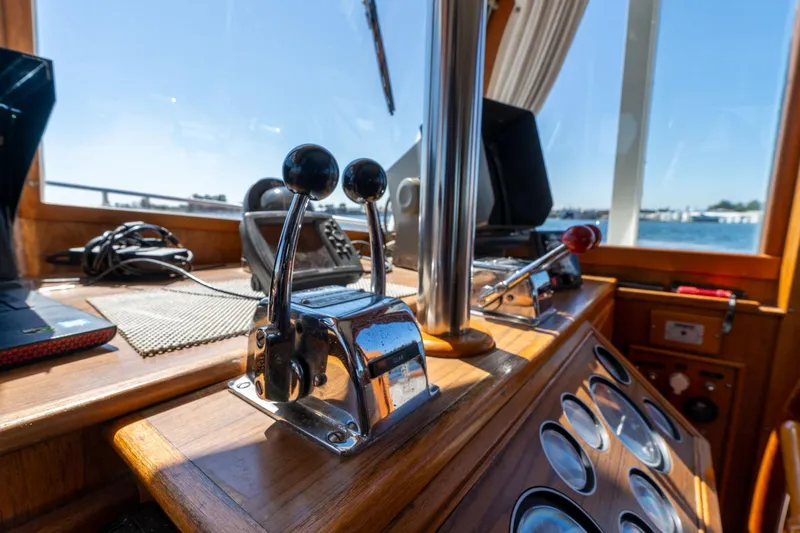 Celebration Yacht Photos Pics Control panel of a 1988 Grand Banks 42 Classic yacht, featuring throttle levers and navigation equipment.