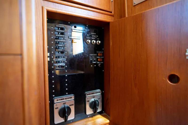 Celebration Yacht Photos Pics Electrical panel inside 1988 Grand Banks 42 Classic yacht, featuring switches and power selectors.