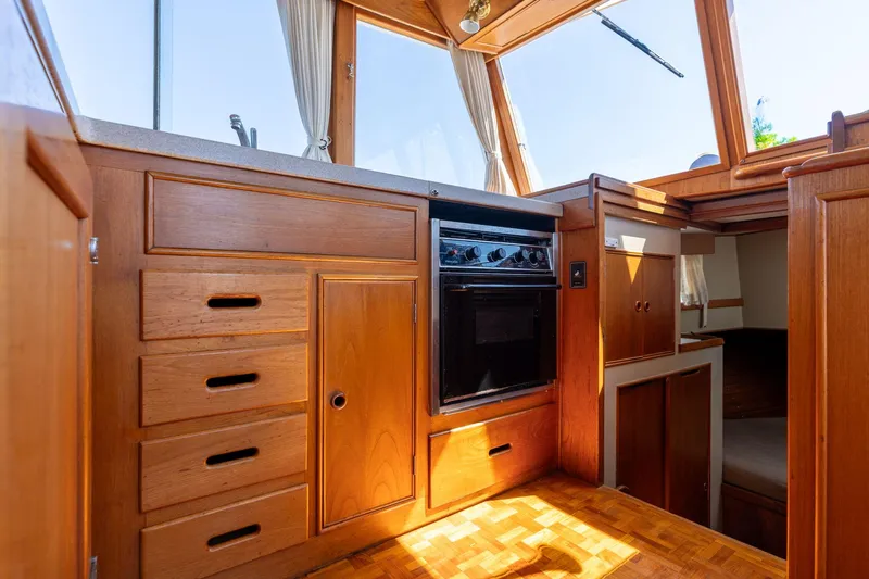 Celebration Yacht Photos Pics Interior of 1988 Grand Banks 42 Classic yacht with wooden cabinetry and built-in oven.