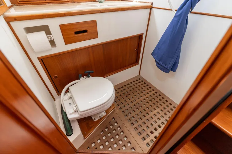 Celebration Yacht Photos Pics 1988 Grand Banks 42 Classic yacht bathroom with wooden accents and marine toilet.