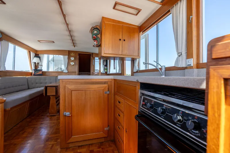 Celebration Yacht Photos Pics Interior of 1988 Grand Banks 42 Classic yacht with wooden cabinetry and modern kitchen amenities.
