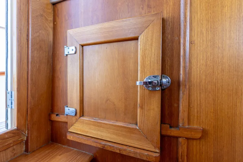 Celebration Yacht Photos Pics Wooden cabinet door with latch on 1988 Grand Banks 42 Classic yacht interior.