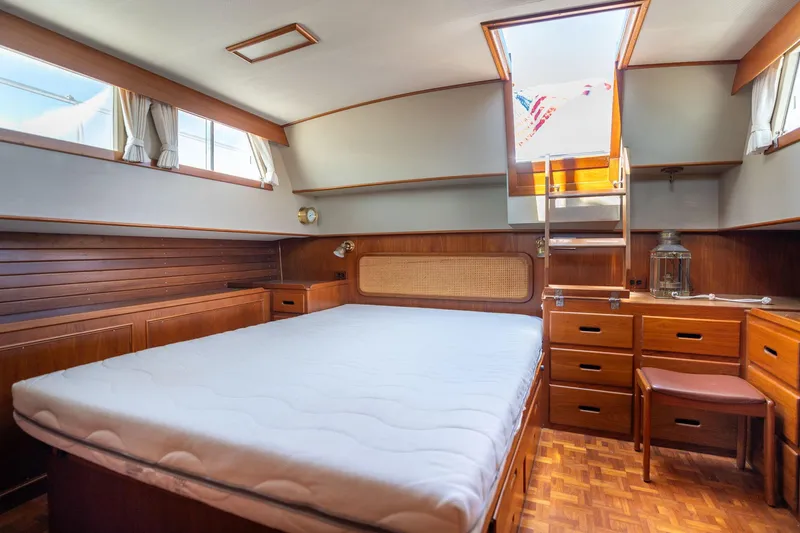 Celebration Yacht Photos Pics Luxurious cabin interior of 1988 Grand Banks 42 Classic yacht with wooden furnishings.