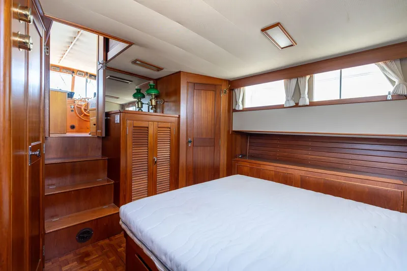 Celebration Yacht Photos Pics Interior of 1988 Grand Banks 42 Classic yacht, featuring wood paneling and a cozy cabin.