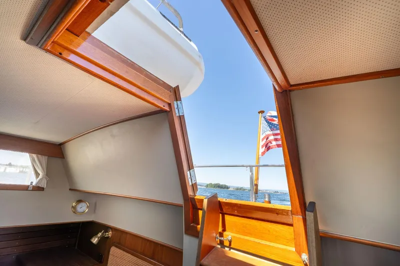 Celebration Yacht Photos Pics Interior view of 1988 Grand Banks 42 Classic yacht with open hatch and American flag.