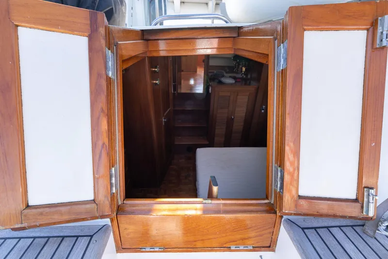 Celebration Yacht Photos Pics Wooden cabin entrance of 1988 Grand Banks 42 Classic yacht, showcasing interior details.