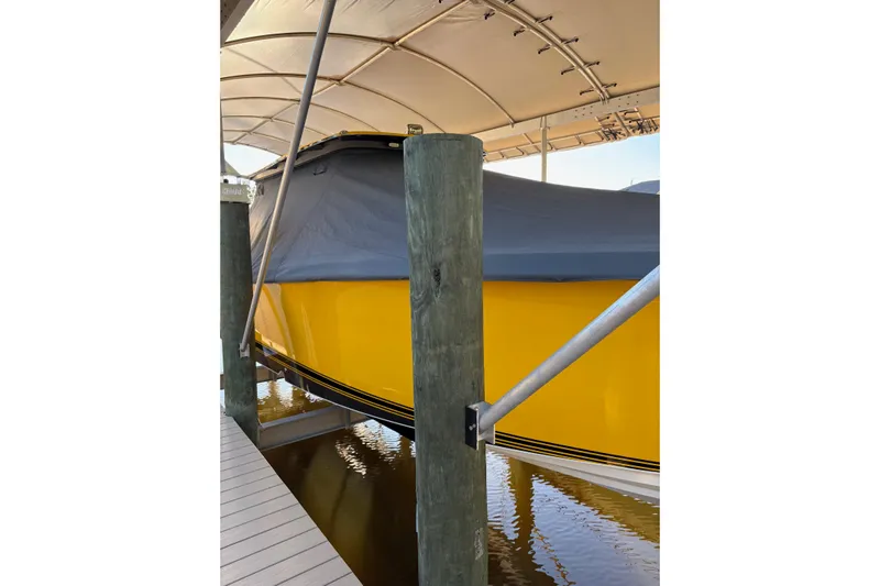  Yacht Photos Pics 2017 Nor-Tech 390 Sport Center Console, yellow hull, covered, docked under canopy.