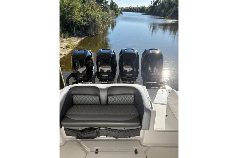  Yacht Photos Pics 2017 Nor-Tech 390 Sport Center Console with quad engines on a serene waterway.