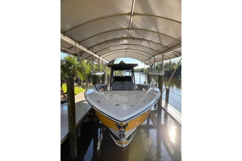  Yacht Photos Pics 2017 Nor-Tech 390 Sport Center Console boat docked under canopy.