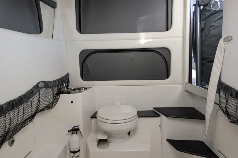  Yacht Photos Pics 2017 Nor-Tech 390 Sport Center Console boat interior with toilet and storage compartments.