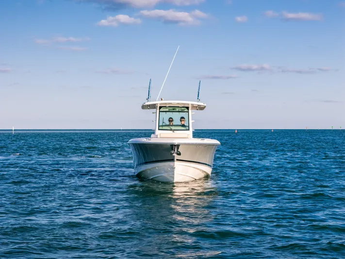 Mama J Yacht Photos Pics 2021 Boston Whaler 330 Outrage boat on open water under clear blue sky.