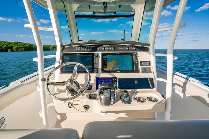 Mama J Yacht Photos Pics 2021 Boston Whaler 330 Outrage helm with advanced navigation system on open water.