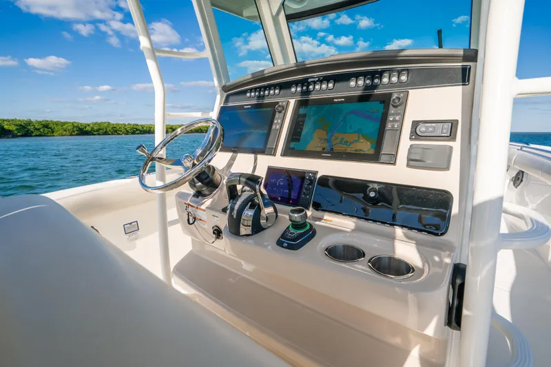 Mama J Yacht Photos Pics 2021 Boston Whaler 330 Outrage helm with advanced navigation systems and ocean view.