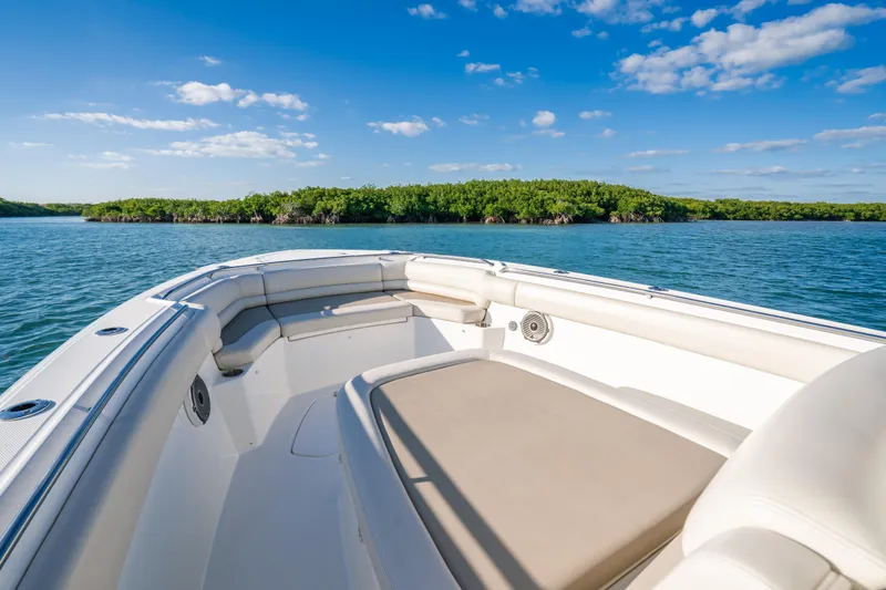 Mama J Yacht Photos Pics 2021 Boston Whaler 330 Outrage boat on calm water with clear blue sky.
