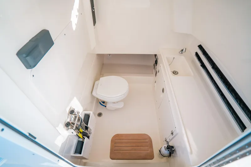 Mama J Yacht Photos Pics 2021 Boston Whaler 330 Outrage boat interior with toilet and sink.