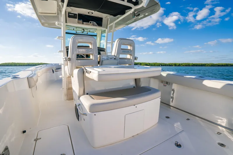 Mama J Yacht Photos Pics 2021 Boston Whaler 330 Outrage boat interior with seating, on a sunny day.