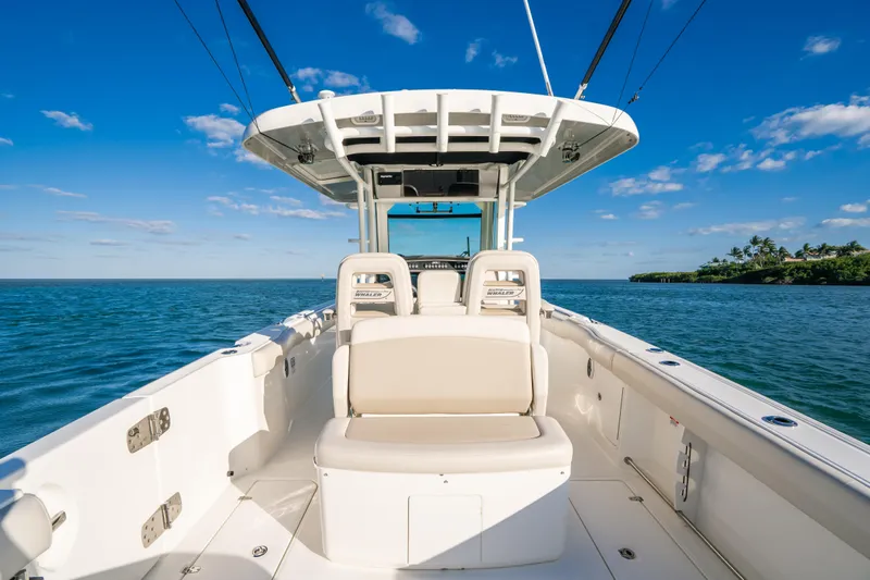 Mama J Yacht Photos Pics 2021 Boston Whaler 330 Outrage boat on open water, clear sky, and scenic view.