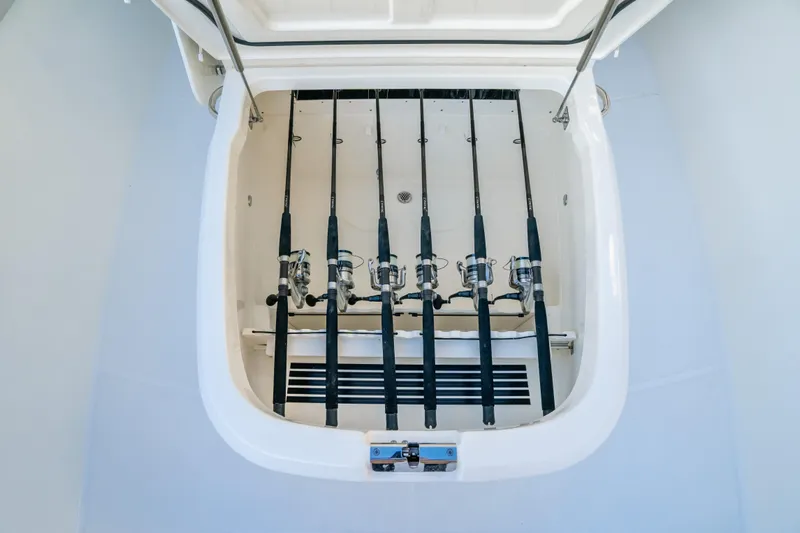 Mama J Yacht Photos Pics 2021 Boston Whaler 330 Outrage fishing rod storage compartment with multiple rods secured.