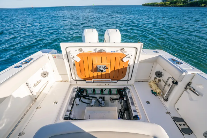 Mama J Yacht Photos Pics 2021 Boston Whaler 330 Outrage boat deck with open hatch, ocean view.
