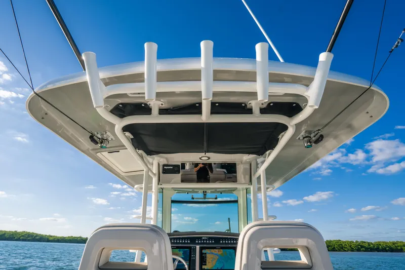 Mama J Yacht Photos Pics 2021 Boston Whaler 330 Outrage boat, featuring a sleek helm and open water backdrop.