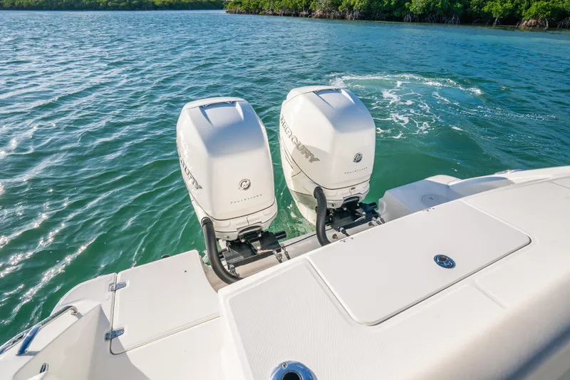 Mama J Yacht Photos Pics 2021 Boston Whaler 330 Outrage boat with dual outboard engines on water.