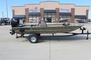 2024 Tracker Grizzly 1754 SC boat on trailer outside dealership.