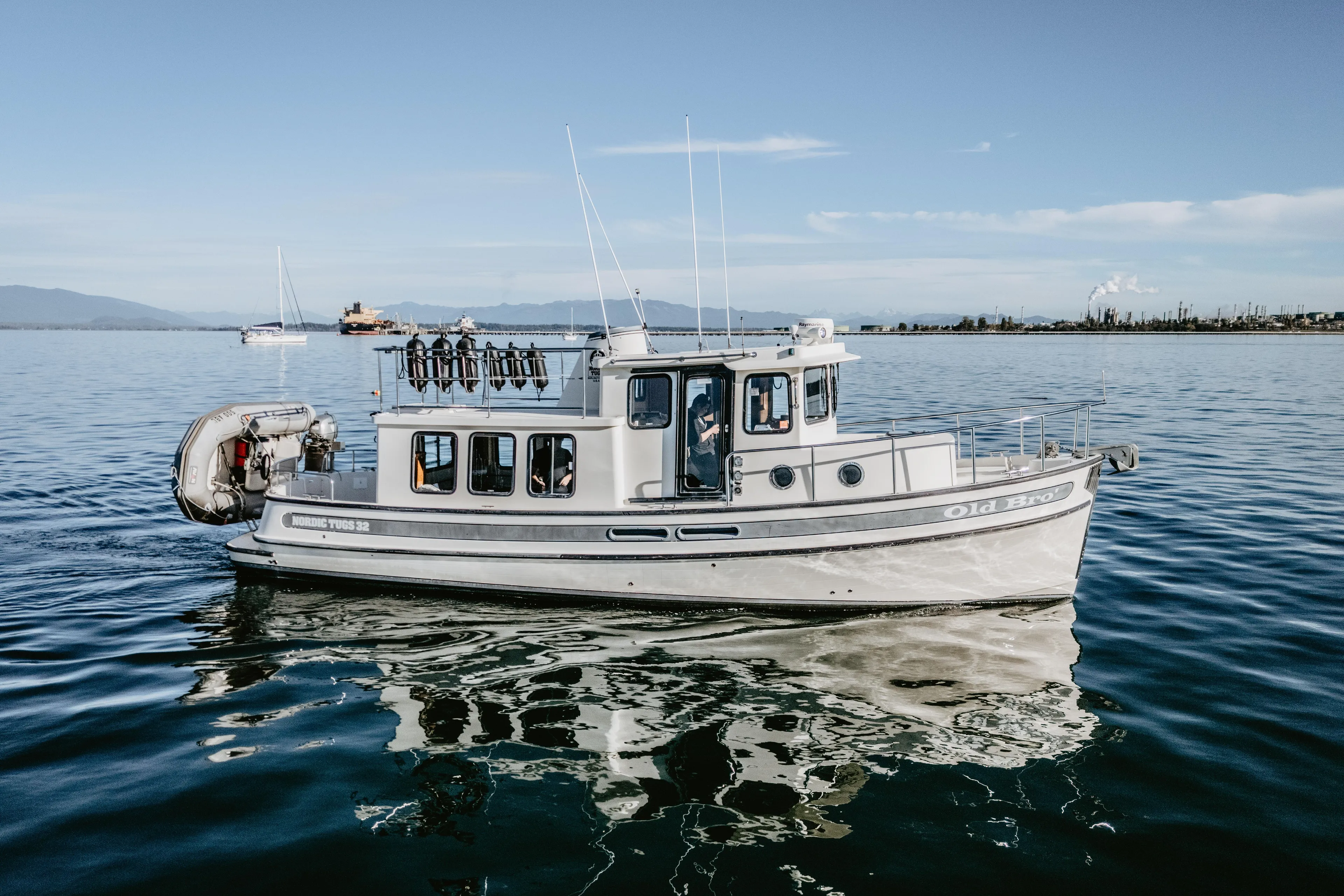 Old Bro Yacht Photos Pics 2001 Nordic Tug 32 boat cruising on calm waters under clear blue skies.