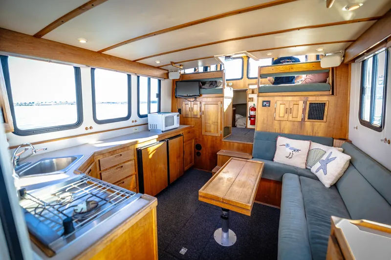 Old Bro Yacht Photos Pics Cozy interior of a 2001 Nordic Tug 32 with kitchen and seating area.
