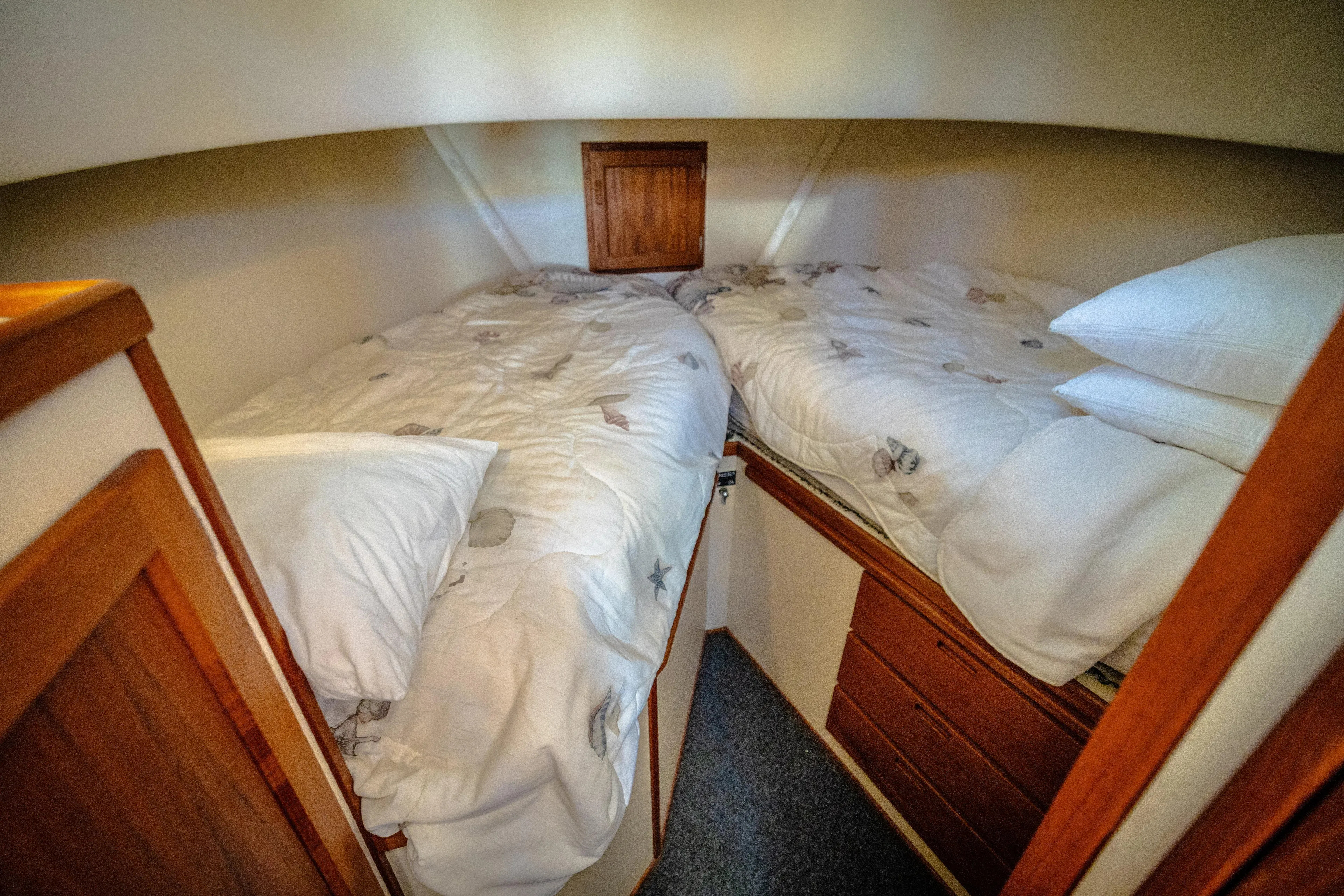 Old Bro Yacht Photos Pics Cozy cabin interior of 2001 Nordic Tug 32 with twin beds and wooden storage.