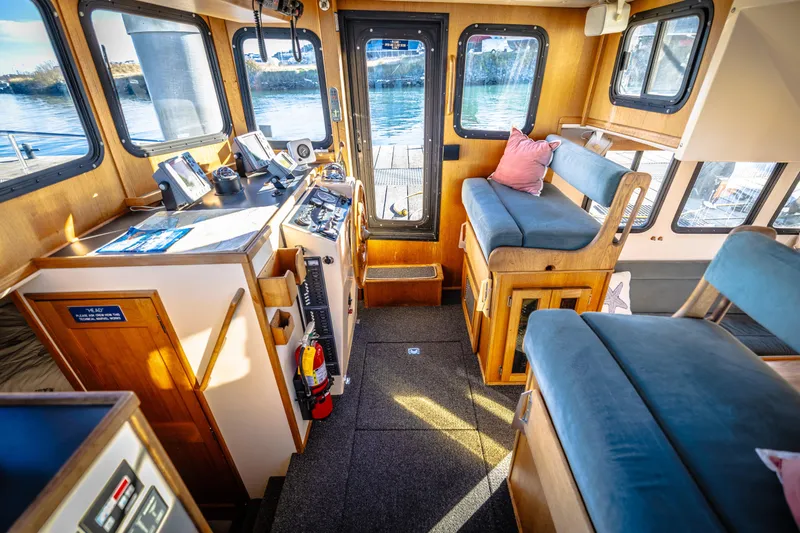 Old Bro Yacht Photos Pics Interior of 2001 Nordic Tug 32 with helm, seating, and navigation equipment.