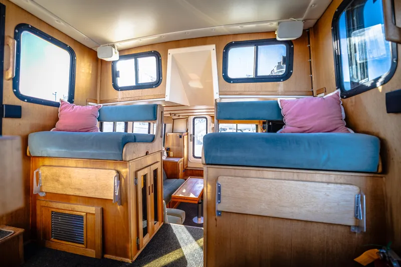 Old Bro Yacht Photos Pics Interior of a 2001 Nordic Tug 32 with cozy seating and wooden finishes.