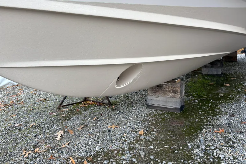  Yacht Photos Pics 2017 Grady-White Freedom 307 boat hull on gravel, supported by blocks.