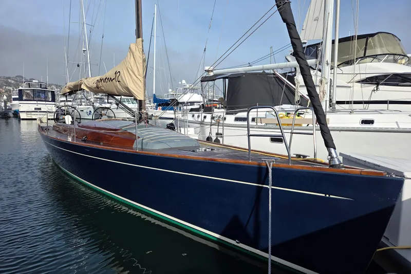 Blue Star Yacht Photos Pics 2018 Tofinou 12 sailboat docked in a marina, featuring sleek design and blue hull.