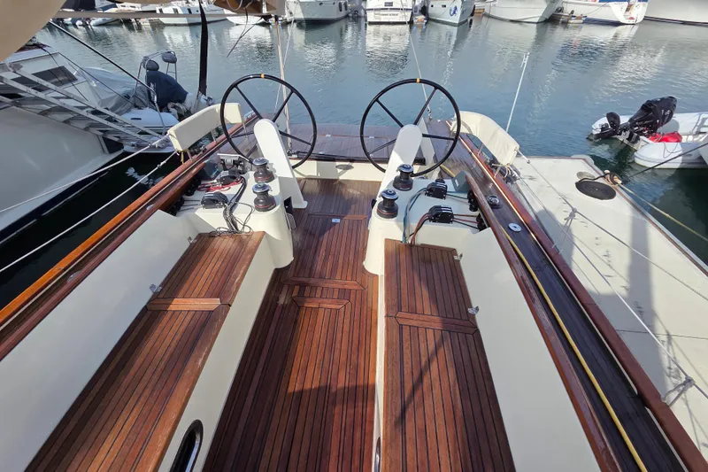 Blue Star Yacht Photos Pics 2018 Tofinou 12 sailboat cockpit with dual steering wheels and wooden deck.