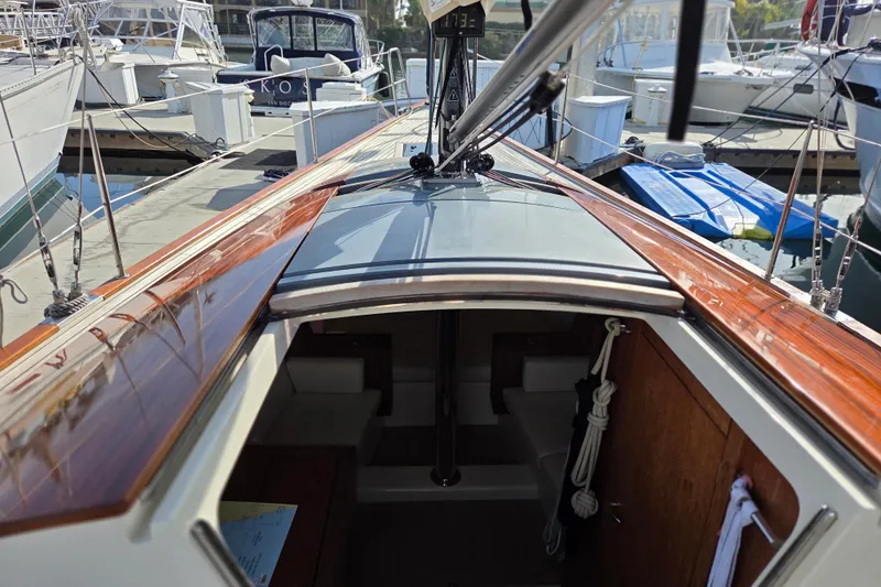 Blue Star Yacht Photos Pics 2018 Tofinou 12 sailboat interior view at marina, showcasing sleek wooden deck.