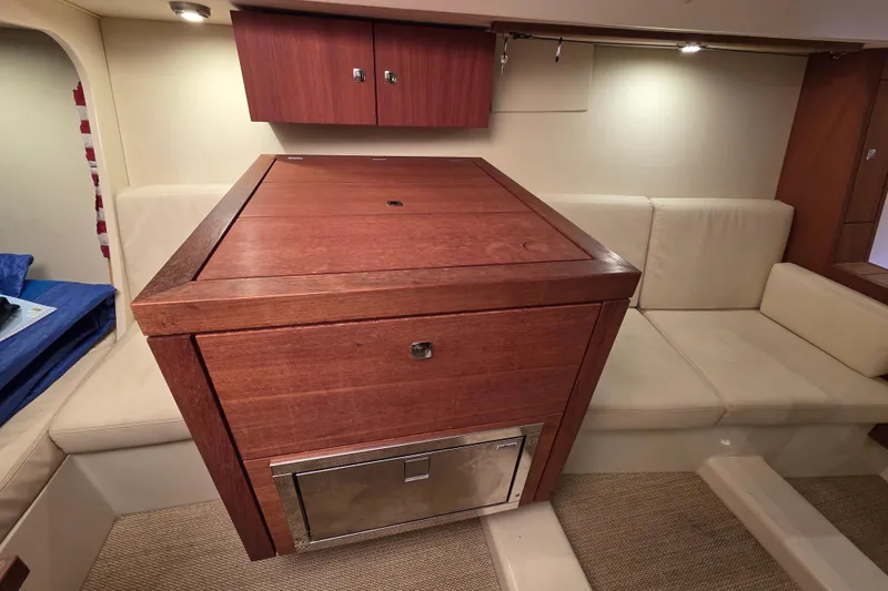 Blue Star Yacht Photos Pics Luxurious interior of 2018 Tofinou 12 yacht with wooden cabinetry and beige seating.