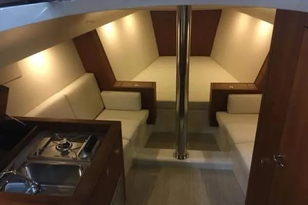 Blue Star Yacht Photos Pics Luxurious interior of 2018 Tofinou 12 yacht with cozy seating and kitchenette.
