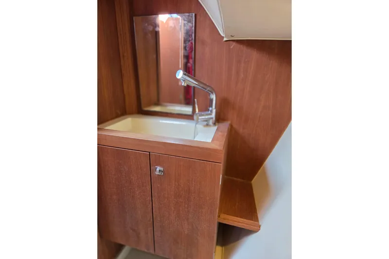 Blue Star Yacht Photos Pics Wooden vanity with sink and mirror in 2018 Tofinou 12 yacht interior.