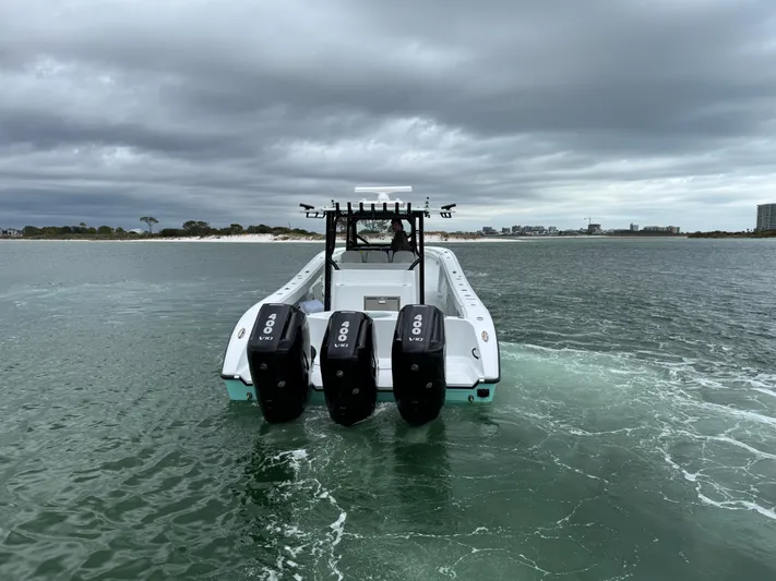  Yacht Photos Pics 2023 Yellowfin 42 Offshore boat with triple outboard engines on open water.