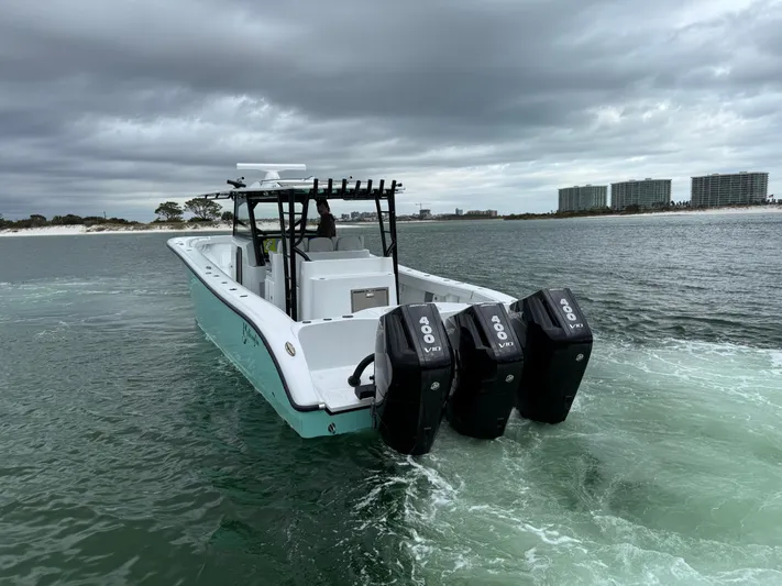  Yacht Photos Pics 2023 Yellowfin 42 Offshore boat with triple engines on open water.