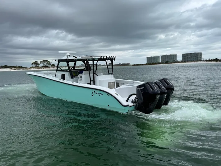  Yacht Photos Pics 2023 Yellowfin 42 Offshore boat cruising on a cloudy day.