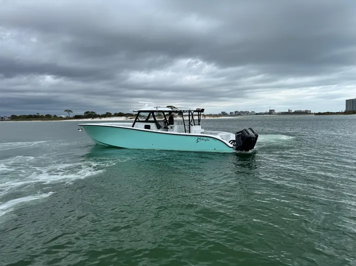  Yacht Photos Pics 2023 Yellowfin 42 Offshore boat cruising on a cloudy day.