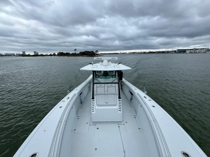  Yacht Photos Pics 2023 Yellowfin 42 Offshore boat on open water under cloudy skies.