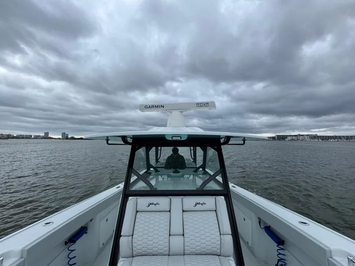  Yacht Photos Pics 2023 Yellowfin 42 Offshore boat on water under cloudy sky.