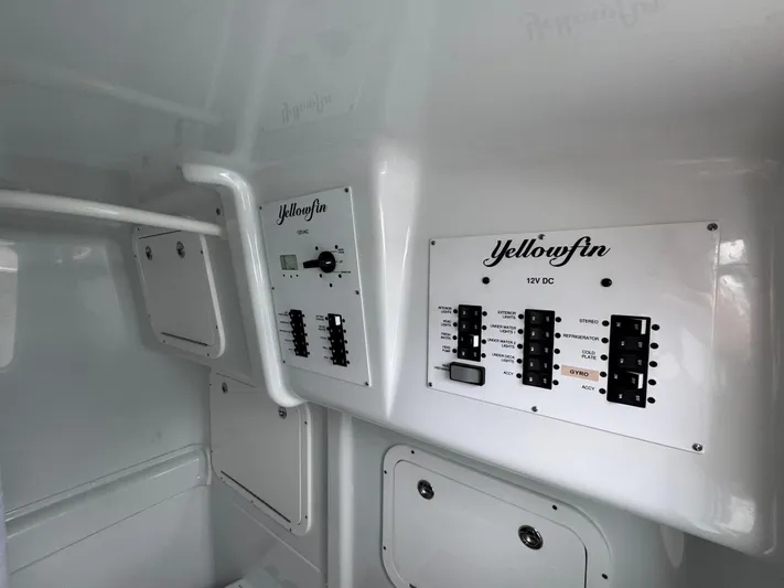 Yacht Photos Pics Control panel of 2023 Yellowfin 42 Offshore boat, featuring electrical switches and labels.