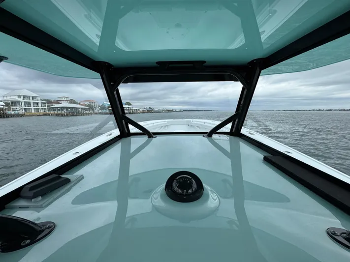  Yacht Photos Pics 2023 Yellowfin 42 Offshore boat interior view, navigating calm waters.