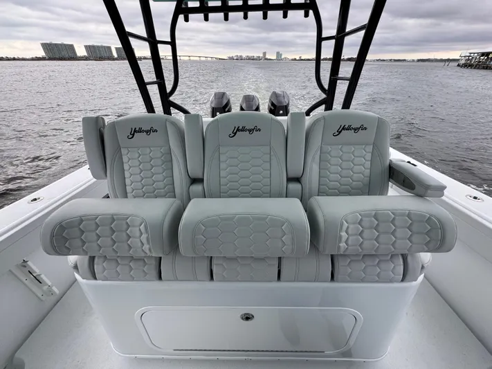  Yacht Photos Pics 2023 Yellowfin 42 Offshore boat seats with hexagonal pattern, overlooking water.