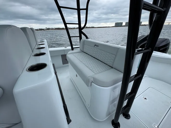  Yacht Photos Pics 2023 Yellowfin 42 Offshore boat interior with seating and cup holders on a cloudy day.