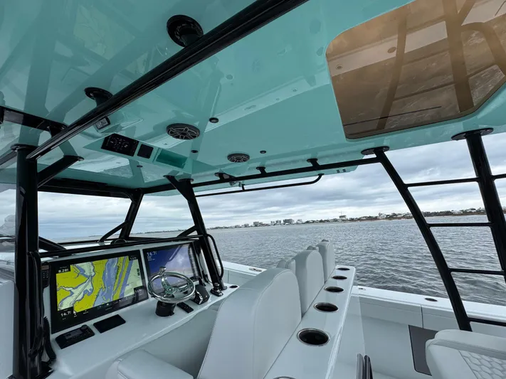  Yacht Photos Pics 2023 Yellowfin 42 Offshore boat interior with navigation screens and seating.