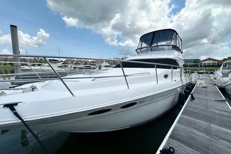 August Moon Yacht Photos Pics 2001 Sea Ray 400 Sedan Bridge yacht docked at marina under cloudy sky.